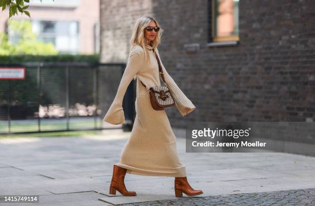 Sue Giers is seen wearing a brown Gucci bag, Celine brown boots, a SoSue beige long dress, vintage Saint Laurent shades on August 15, 2022 in...