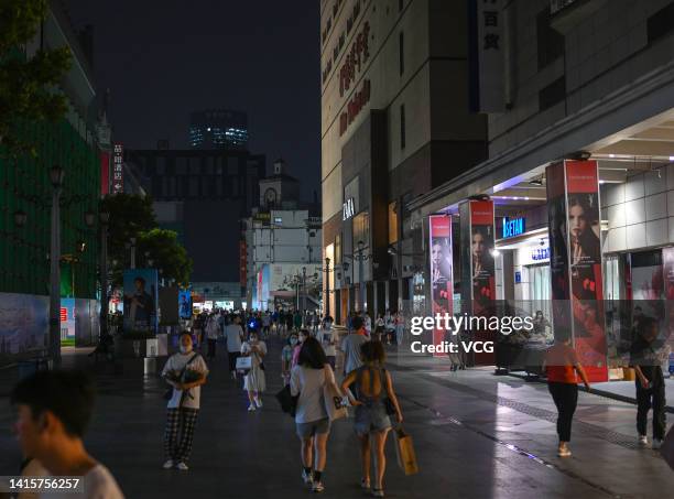 People visit the Taikoo Li shopping complex as lights are partially turned off to conserve energy on August 18, 2022 in Chengdu, Sichuan Province of...