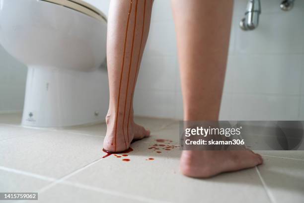 close up young adult female pregnant standing in bathroom and bleeding  and abort in bathroom  healthy and medical concept - period blood stockfoto's en -beelden