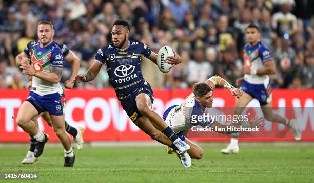 Hamiso Tabuai-Fidow of the Cowboys gets past Reece Walsh of the Warriors during the round 23 NRL match between the North Queensland Cowboys and the...