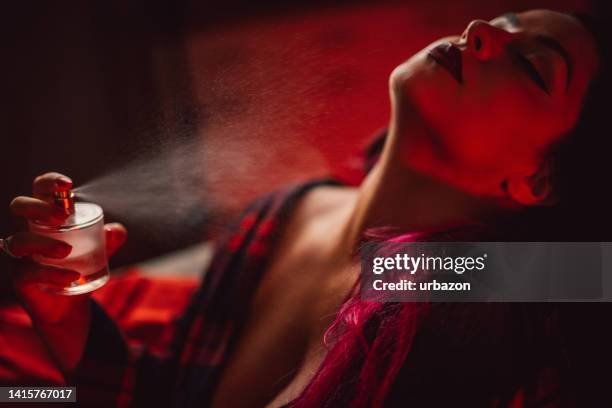 young plus size woman putting on a perfume - man applying perfume stock pictures, royalty-free photos & images