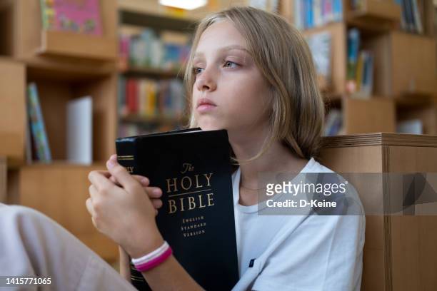 holy bible - child praying school stock pictures, royalty-free photos & images