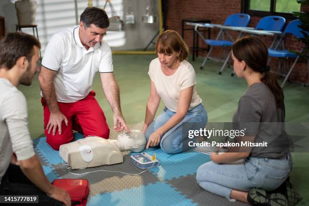 the teacher is training on how to use the basic aed correctly. - aed stock pictures, royalty-free photos & images