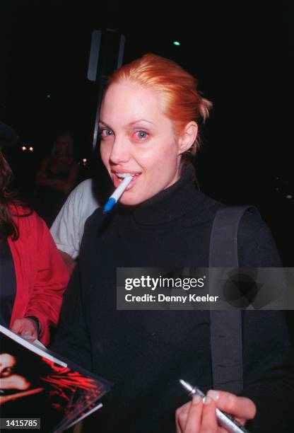 Angelina Jolie signing autographs outside Mr. Chow''s restaurant, July 18 Beverly Hills, California.