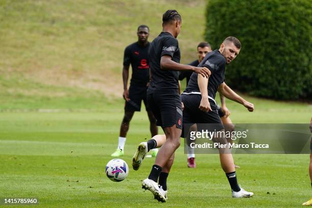 Emil Roback and Ante Rebic in action during an AC Milan training session at Milanello on August 19, 2022 in Cairate, Italy.