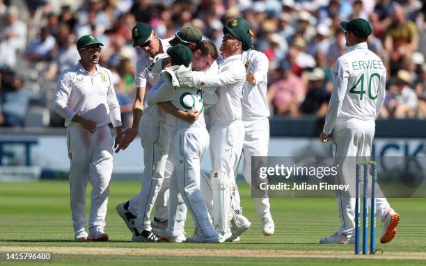 Anrich Nortje of South Africa celebrates with Dean Elgar after taking the wicket of Jonny Bairstow of England during day three of the first...