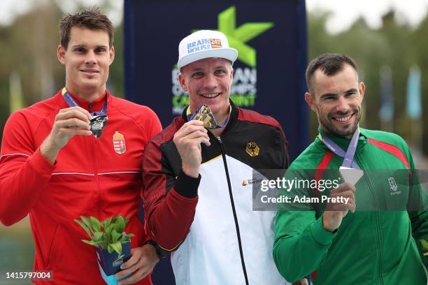 Silver Medalist, Adam Varga of Hungary, Gold Medalist, Jacob Schopf of Germany and Bronze Medalist, Fernando Pimenta of Portugal celebrate in the...