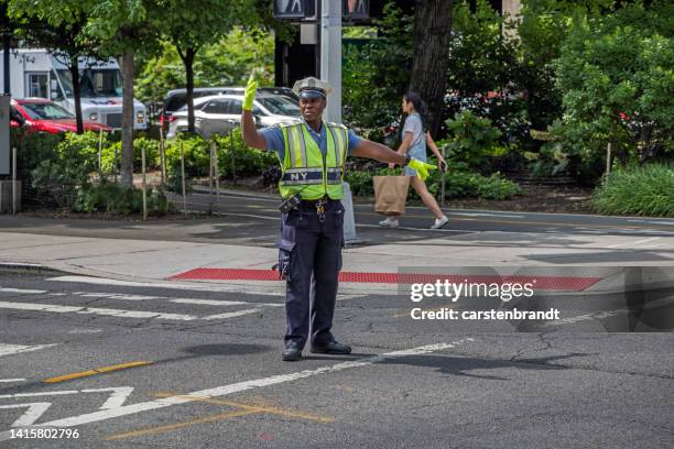 police person regulating the traffic - verkeerspolitie stockfoto's en -beelden