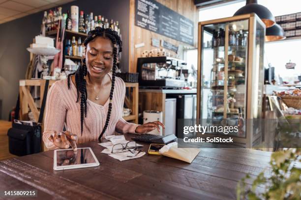 businesswoman calculating finances - small business administration stock pictures, royalty-free photos & images