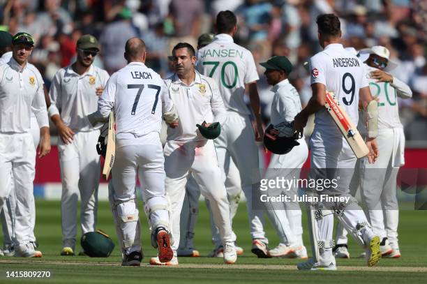 Dean Elgar of South Africa is congratulated by James Anderson and Jack Leach of England as South Africa take the win during day three of the first...