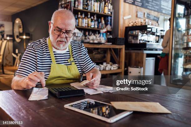 business owner calculating his finances - financial planning seniors stock pictures, royalty-free photos & images