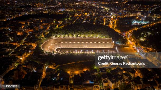 aerial photo of the panathinaic stadium in athens, greece at night - olympic stadium athens stock pictures, royalty-free photos & images