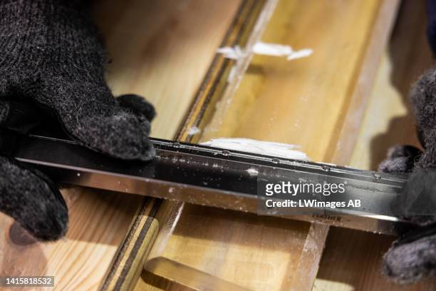 Sepp Kipfstuhl of the East Greenland Ice-Core Project carefully cleans the plane surface of the ice core slab, which later will be cut into pieces 2,...