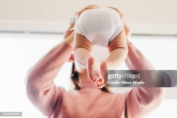 baby legs and bottom in diaper and body suit - baby bottom stock pictures, royalty-free photos & images