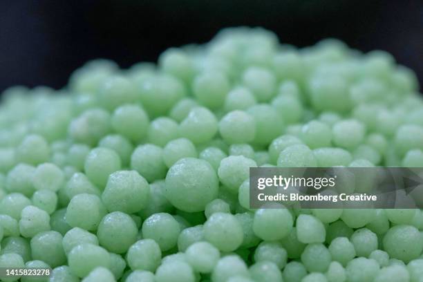 close-up of green phosphate fertilizer granules - nitrogen stock pictures, royalty-free photos & images