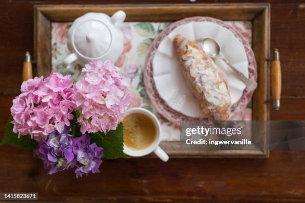 high angle view of tray with flowers, coffee and croissant - hydrangea lifestyle stockfoto's en -beelden