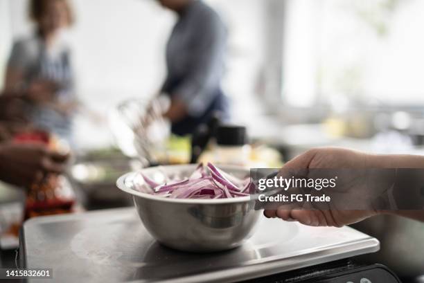 bowl of onion in a scale - kitchen scale stock pictures, royalty-free photos & images