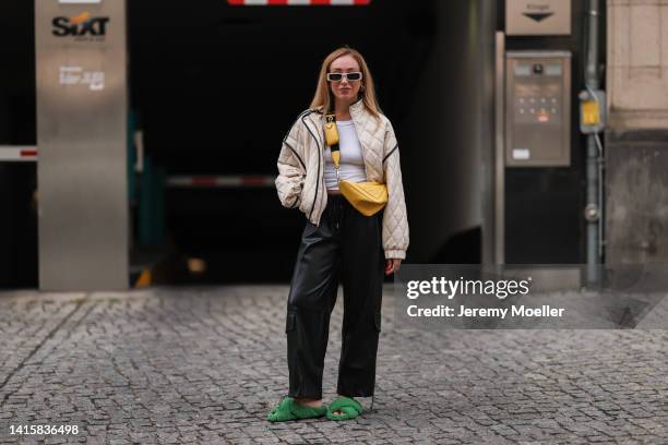 Sonia Lyson wearing Prada yellow triangle leather bag, Dorothee Schumacher green fluffy sandals, The Frankie Shop vegan leather pants, Weekday white...