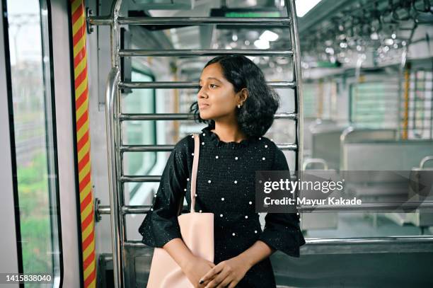 portrait of a teenage girl standing in train - 12 year old indian girl stock pictures, royalty-free photos & images