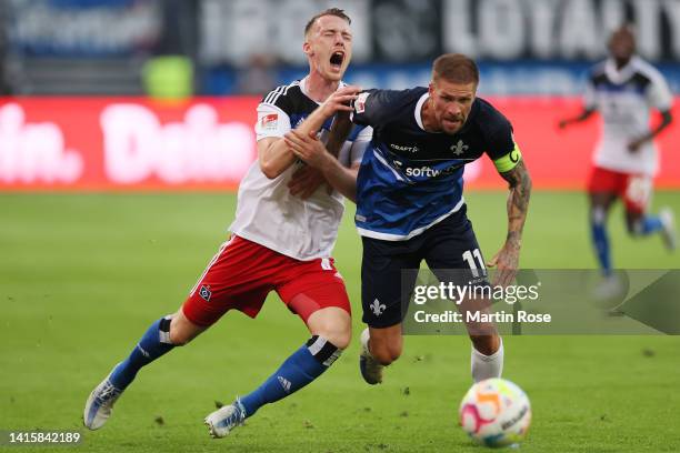 Sebastian Schonlau of Hamburger SV is challenged by Tobias Kempe of Darmstadt during the Second Bundesliga match between Hamburger SV and SV...