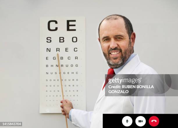 screen shot of caucasian doctor checking eyesight with snellen chart by video call in ophthalmological clinic. healthcare and medicine concept. - eyesight problem stock pictures, royalty-free photos & images