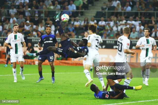 Wilfried Kanga of Hertha tries to score with an overhead kick whilst under pressure from Ko Itakura of Moenchengladbach during the Bundesliga match...