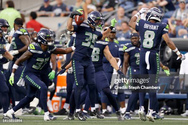 Joey Blount celebrates with Coby Bryant of the Seattle Seahawks after recovering an onside kick in the fourth quarter during the preseason game...