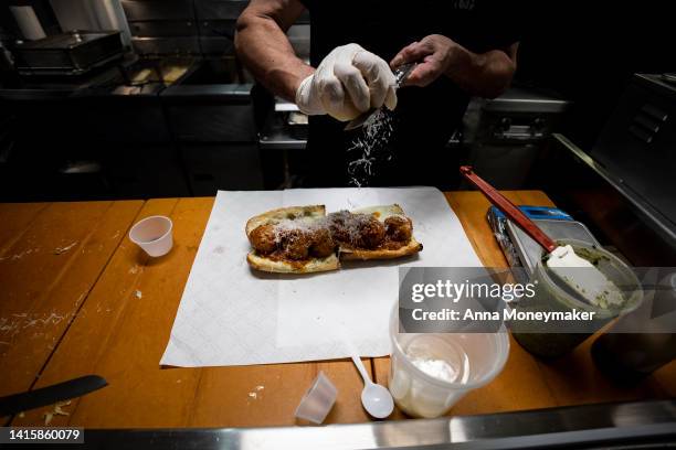 Parmesan is grated over a meatball sub at Bub and Pop's on August 19, 2022 in Washington, DC. Since the beginning of Covid-19 restaurant owners have...