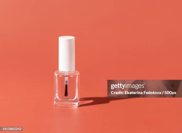 clear glass refillable bottle with brush cap on pink,hard shadow nail product mockup - vernis a ongle photos et images de collection