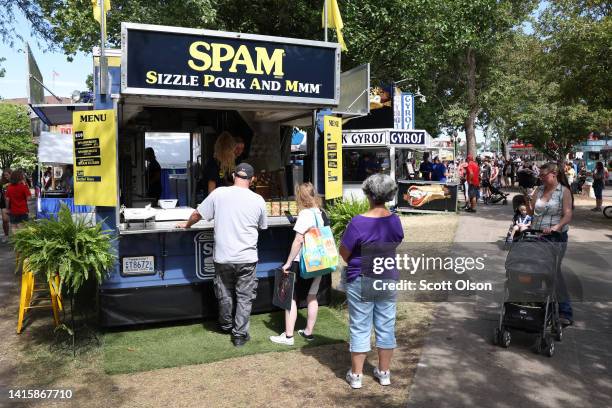 Visitors to the Iowa State Fair visit a food booth specializing in Spam products on August 19, 2022 in Des Moines, Iowa. The fair which attracts...