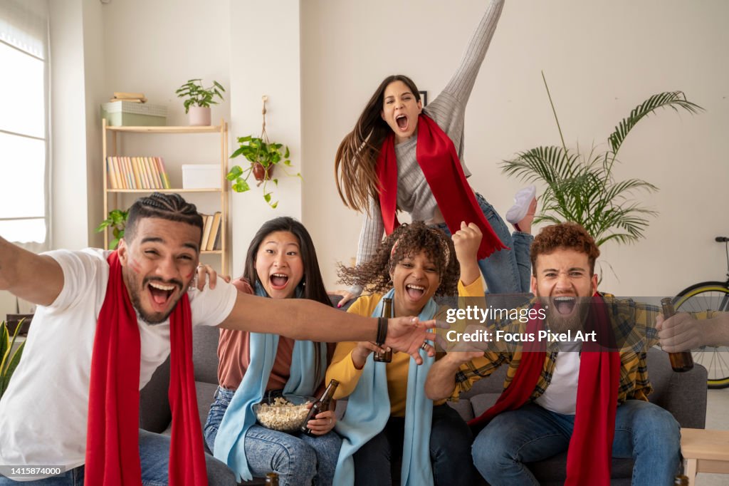 Excited fans shouting while watching match on TV.