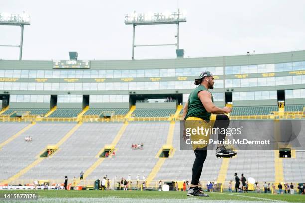 David Bakhtiari of the Green Bay Packers warms up before a preseason game against the New Orleans Saints at Lambeau Field on August 19, 2022 in Green...