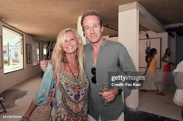 Fiona Gélin and photographer Jean Bernard Thiele attend the JB Thiele Exhibition Preview at Galerie Saint Simon on August 19, 2022 in Saint Tropez,...