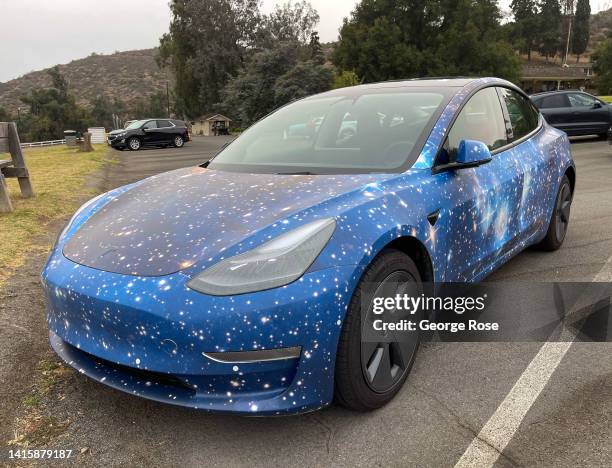 Tesla featuring a custom color paint job depicting the universe and stars is viewed parked at Will Rogers State Park on July 29, 2022 in Los Angeles,...