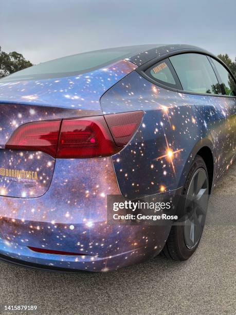 Tesla featuring a custom color paint job depicting the universe and stars is viewed parked at Will Rogers State Park on July 29, 2022 in Los Angeles,...