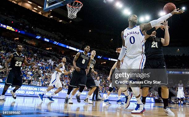 Kansas Jayhawks forward Thomas Robinson and Purdue Boilermakers guard/forward D.J. Byrd fought for a rebound during the first half in Sunday's...