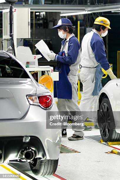 Fuji Heavy Industries Ltd. Employees inspect Toyota Motor Corp. 86 sports coupes on the Subaru BRZ and Toyota 86 production line at Fuji Heavy's...