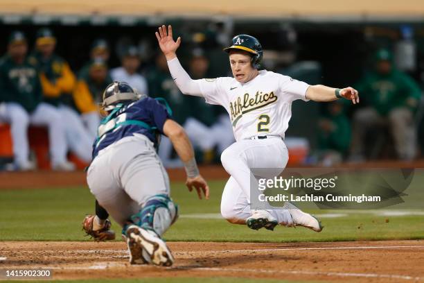 Nick Allen of the Oakland Athletics is tagged out at home plate by catcher Cal Raleigh of the Seattle Mariners in the bottom of the fifth inning at...