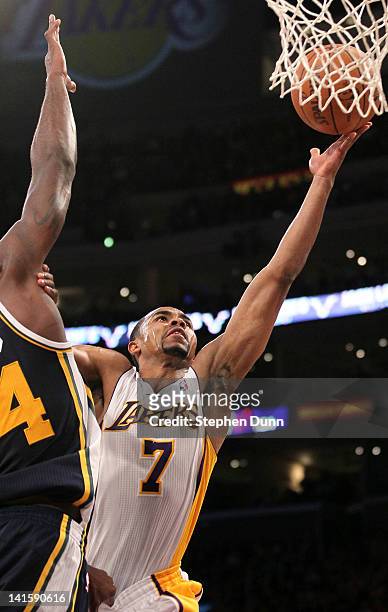 Ramon Sessions of the Los Angeles Lakers shoots over Paul Millsap of the Utah Jazz at Staples Center on March 18, 2012 in Los Angeles, California....