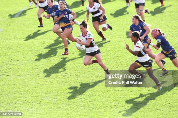 Hayley Hutana of North Harbour makes a break during the round six Farah Palmer Cup match between North Harbour and Otago at North Harbour Stadium, on...