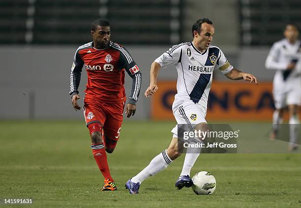 Landon Donovan of the Los Angeles Galaxy is pursued by Ashtone Morgan of Toronto FC during a CONCACAF Champions League game at The Home Depot Center...