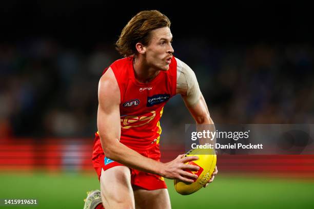 Noah Anderson of the Suns runs with the ball during the round 23 AFL match between the North Melbourne Kangaroos and the Gold Coast Suns at Marvel...