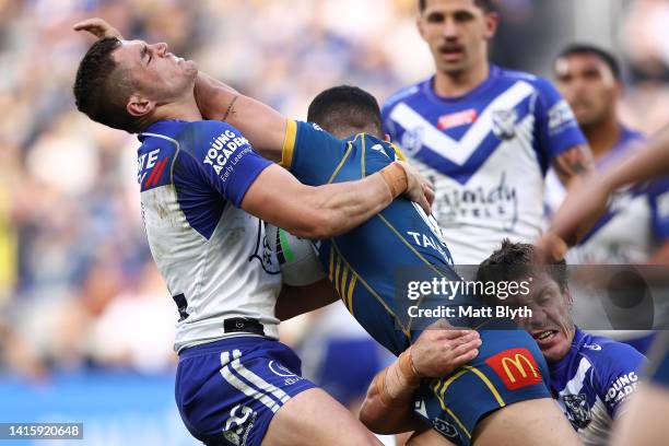 Dylan Brown of the Eels fends off Kyle Flanagan of the Bulldogs during the round 23 NRL match between the Parramatta Eels and the Canterbury Bulldogs...