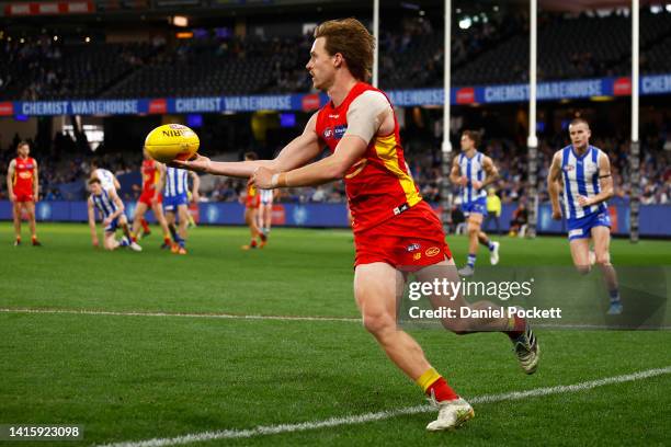 Noah Anderson of the Suns keeps the ball in play during the round 23 AFL match between the North Melbourne Kangaroos and the Gold Coast Suns at...