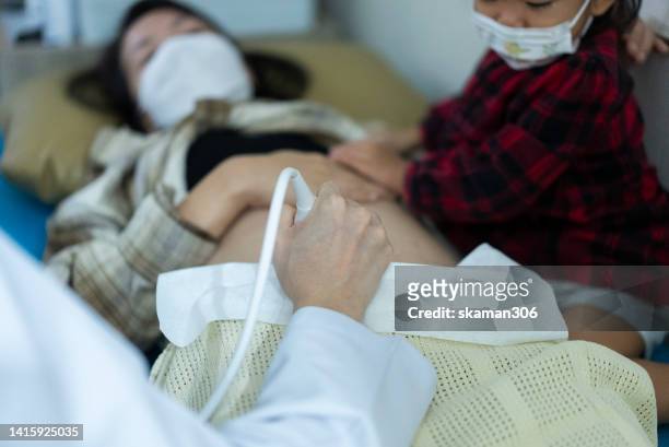 doctor used an ultrasound sonogram  monitor for  the fetus 12 weeks young adult patient pregnant - twin ultrasound stock pictures, royalty-free photos & images