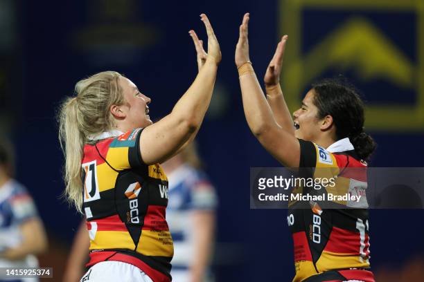 Ashlee Gaby-Sutherland of Waikato and team mate Merania Paraone celebrate during the round six Farah Palmer Cup match between Waikato and Auckland at...