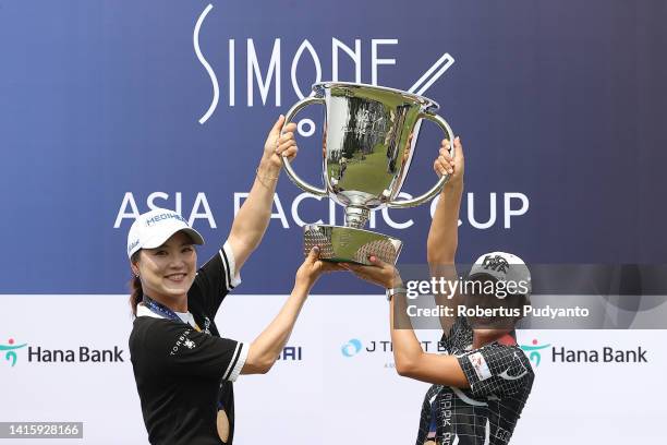 So Yeon Ryu and Bo-mee Lee of South Korea lifts the trophy at the award ceremony as they win the team competition during day three of the Simone Asia...