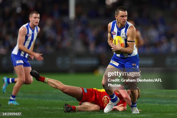 Luke Davies-Uniacke of the Kangaroos evades a tackle during the round 23 AFL match between the North Melbourne Kangaroos and the Gold Coast Suns at...