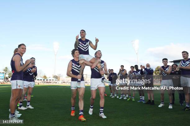 Michael Walters of the Dockers is chaired off by Nat Fyfe of the Dockers and David Mundy of the Dockers during the round 23 AFL match between the...