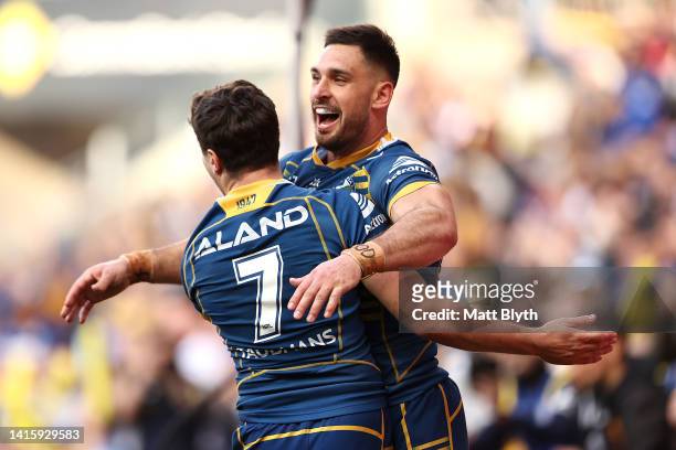 Ryan Matterson of the Eels celebrates with team mates after scoring a try during the round 23 NRL match between the Parramatta Eels and the...